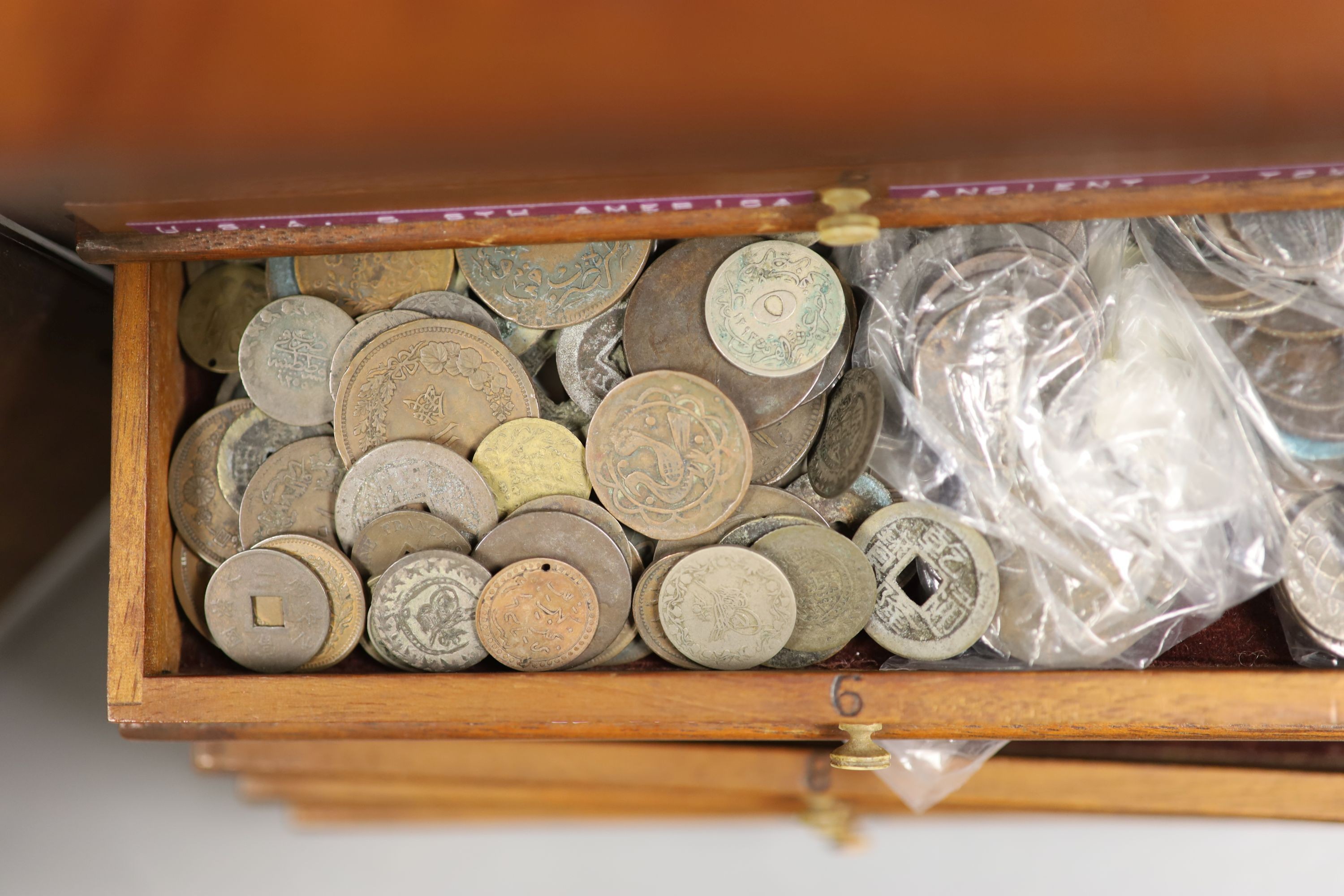 A mahogany coin collector's cabinet, fitted single door enclosing 10 drawers containing British and other coins (Georgian and later), tokens, etc.